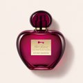 Flakon Banderas Her Secret Temptation EDT 80 ml na pudrově růžovém pozadí – MrRizz